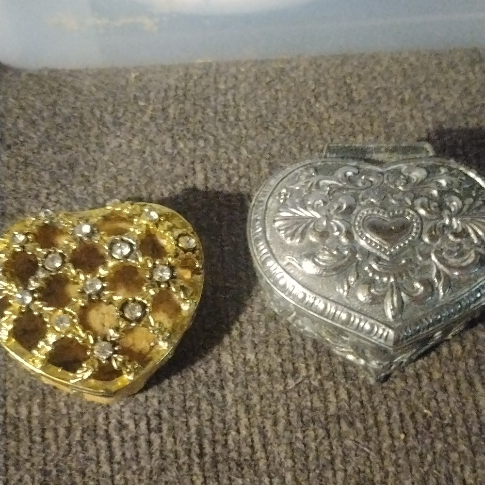 Two heart-shaped trinket boxes one silver one gold